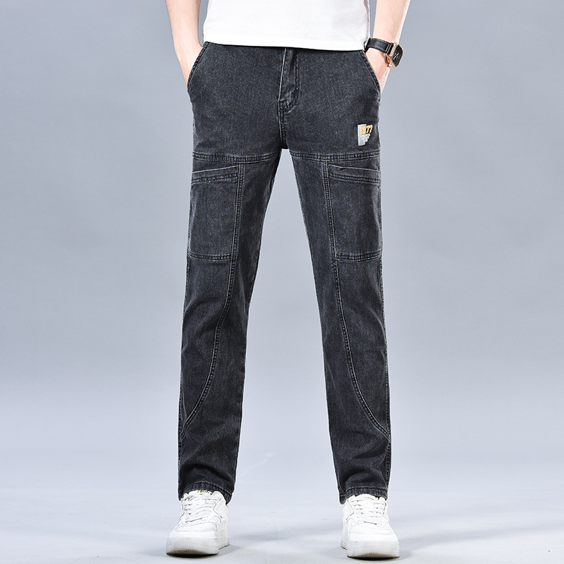 Faded black tapered denim jeans with cargo-inspired seam detailing and mid-rise stretch fit