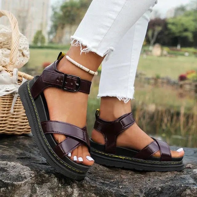 Women's cross strap platform sandals in neutral tone with thick cushioned sole and chic strappy silhouette