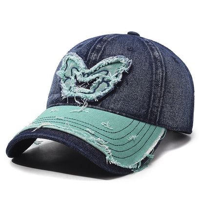 Washed denim baseball cap with embroidered butterfly accent, curved brim, retro streetwear style