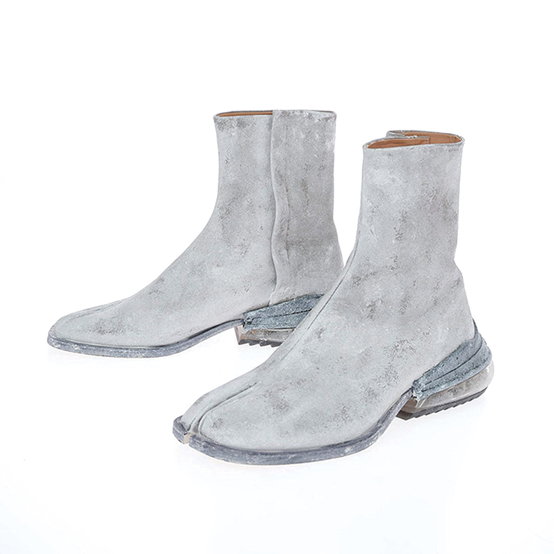 Black vegan leather split-toe tabi boot with air-cushioned heel, bold fashion-forward silhouette