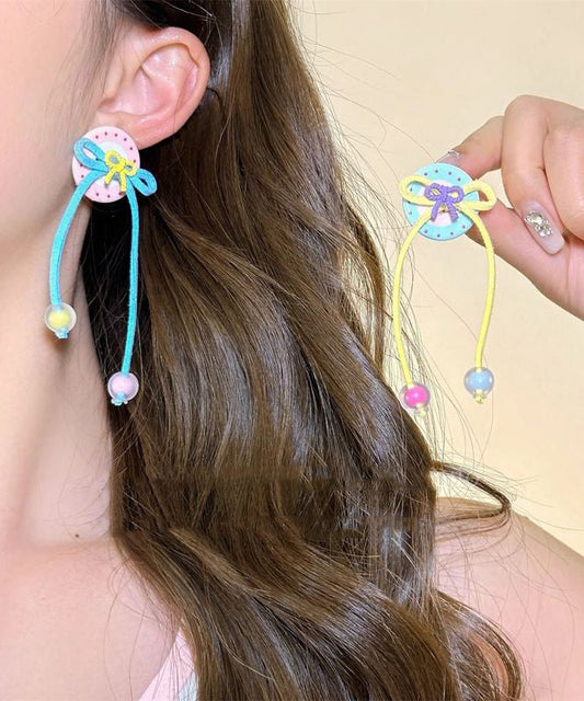 Boucles d'oreilles pendantes à pompon et nœud papillon arc-en-ciel faites à la main - Wavlynn