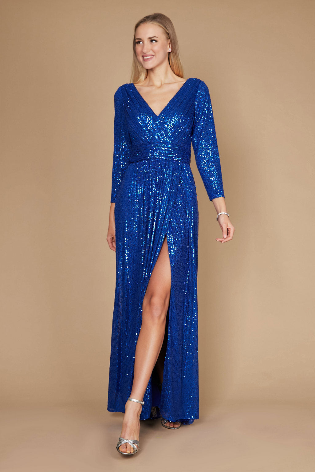 Floor-length silver sequin prom gown with long sleeves, deep V-neckline, hand-beaded embellishments