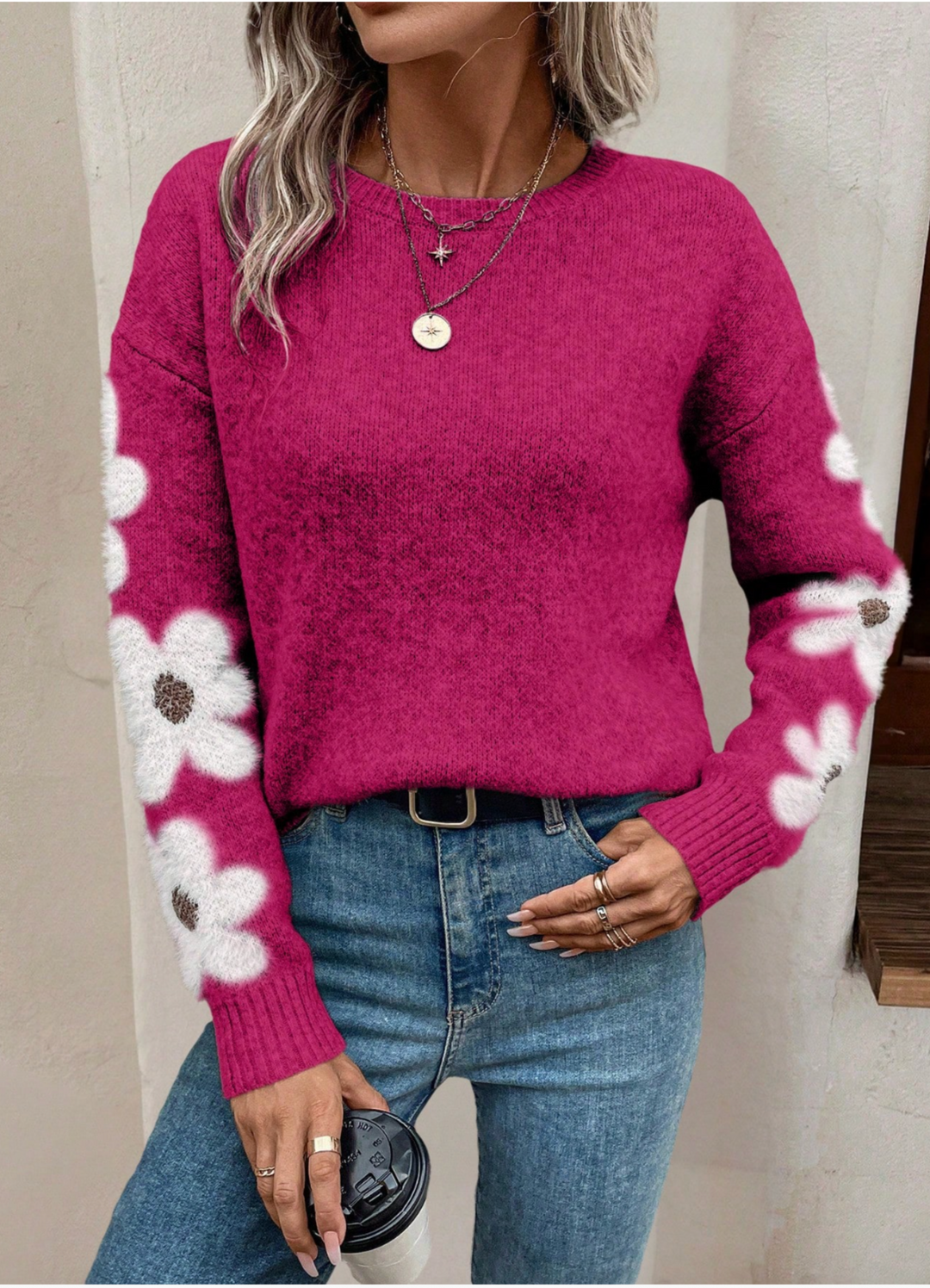 Cream relaxed-fit knit sweater with feminine daisy embroidery detail along the sleeves