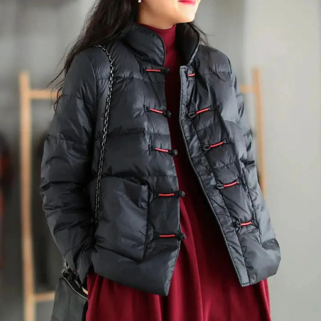 Black insulated down jacket with mandarin collar, knotted toggle closures, and oversized patch pockets