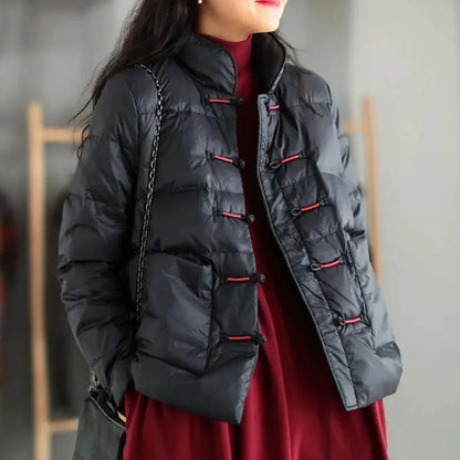 Black insulated down jacket with mandarin collar, knotted toggle closures, and oversized patch pockets