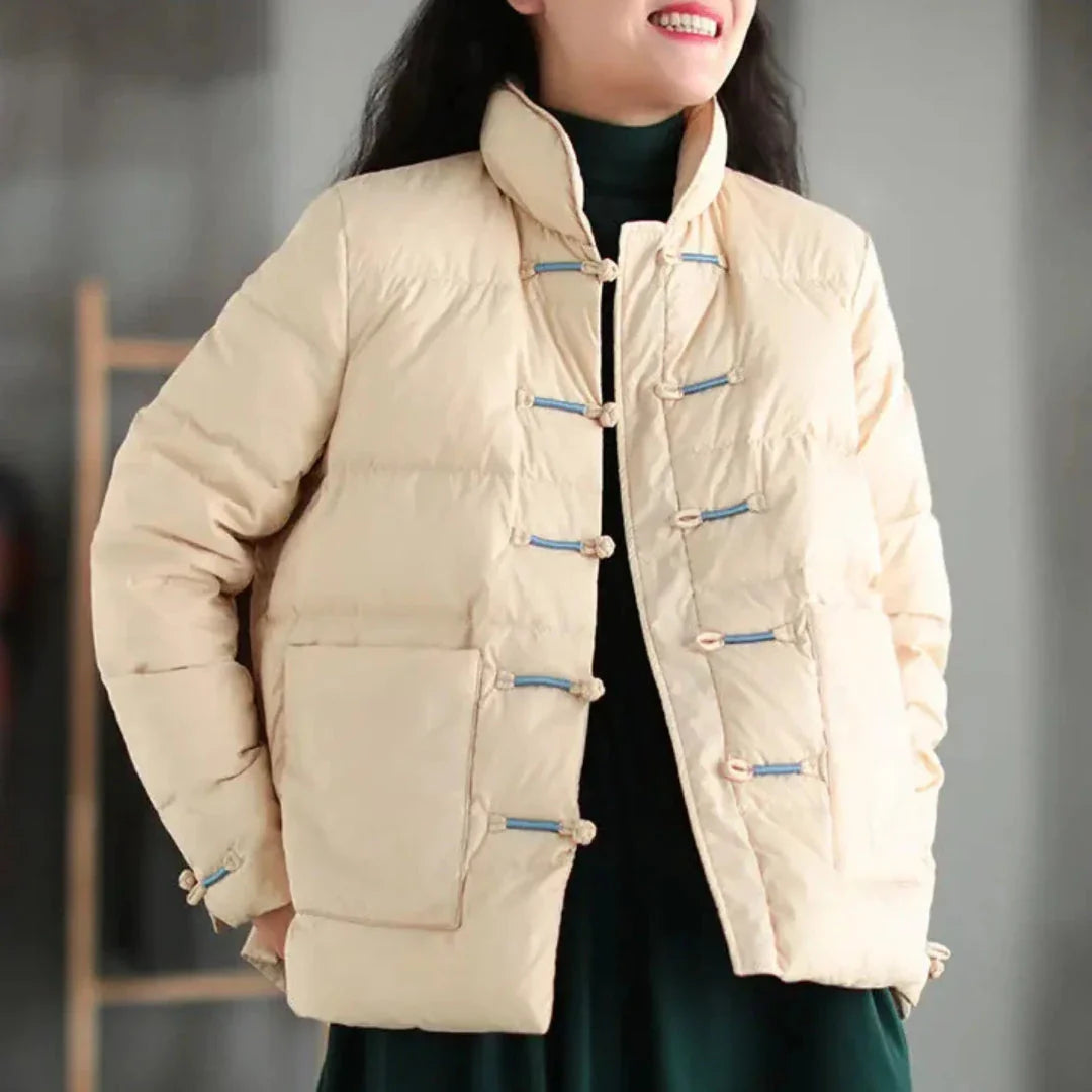 Black insulated down jacket with mandarin collar, knotted toggle closures, and oversized patch pockets