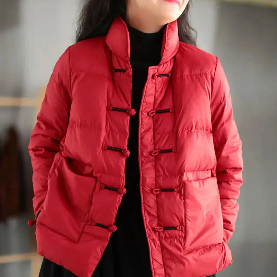 Navy blue knotted down jacket with mandarin collar, toggle closures, and oversized patch pockets
