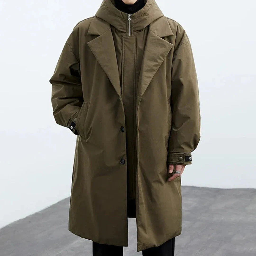 Oversized hooded trench coat in neutral tone with detachable hood and mid-thigh windbreaker silhouette