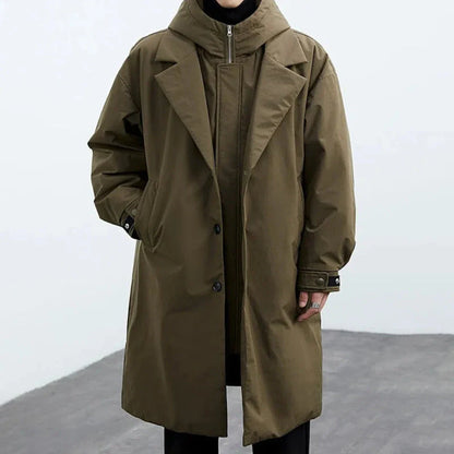 Oversized hooded trench coat in neutral tone with detachable hood and mid-thigh windbreaker silhouette
