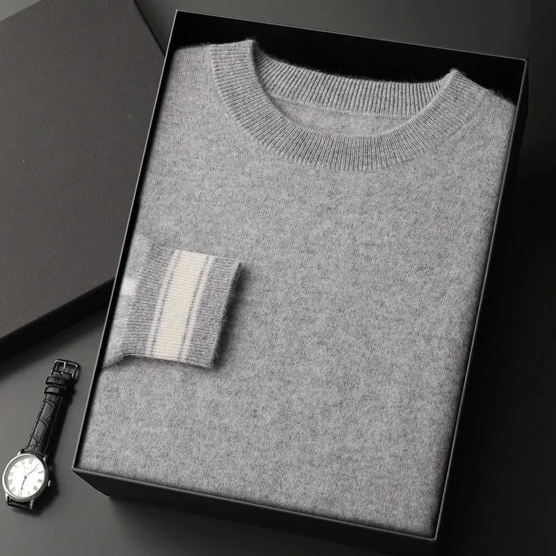 Ivory crewneck cashmere pullover with ribbed trim and subtle contrast stripe accent on cuffs