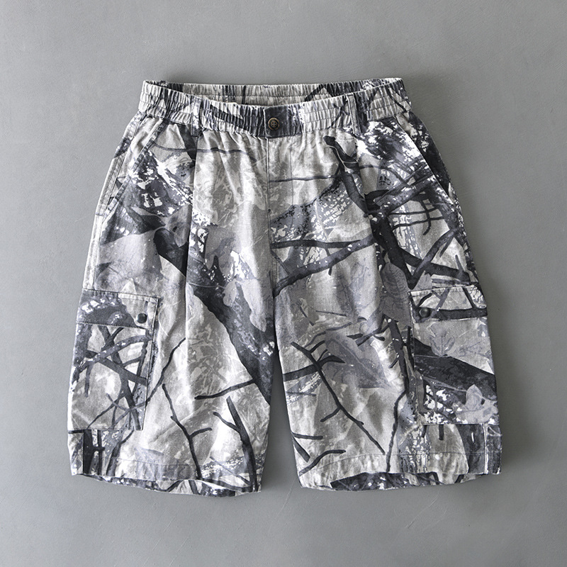 Men's distressed camouflage cargo shorts with dual button-flap pockets and elastic waist