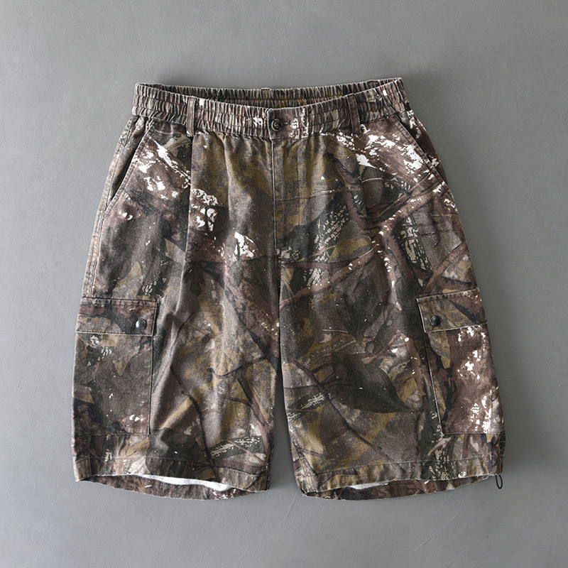 Distressed camo cargo shorts with elastic waist, button closure, and dual flap pockets for rugged style