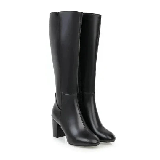 Women's knee-high heeled boots in sleek silhouette with stiletto heel, tall shaft, and polished everyday style