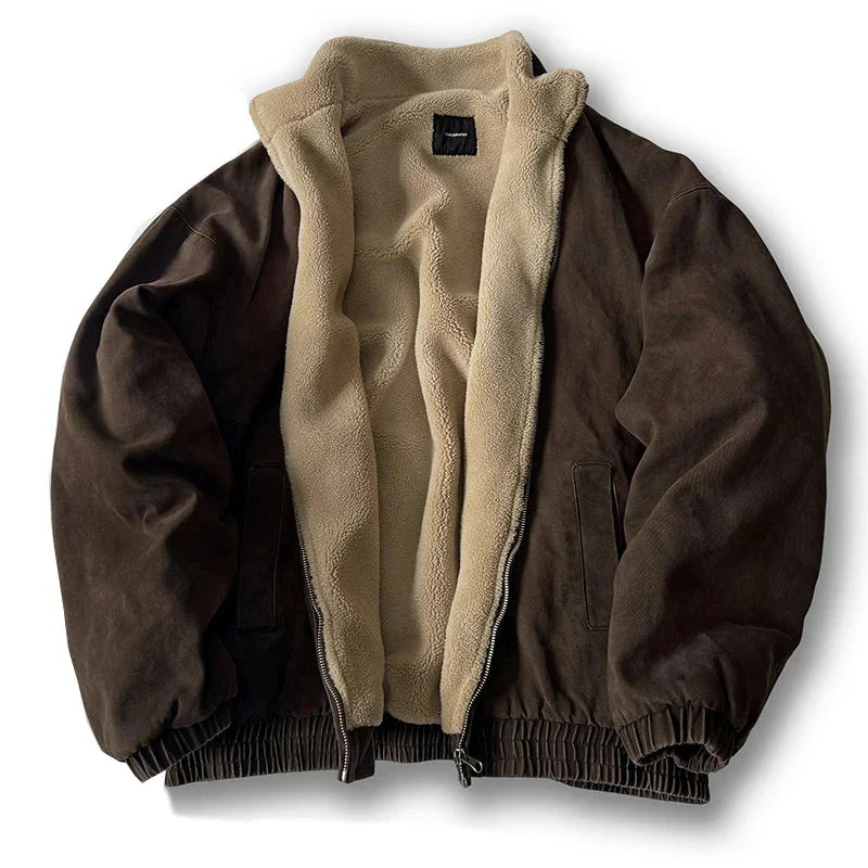 Navy fleece-lined padded jacket with clean silhouette, elastic hem, and durable cotton canvas exterior