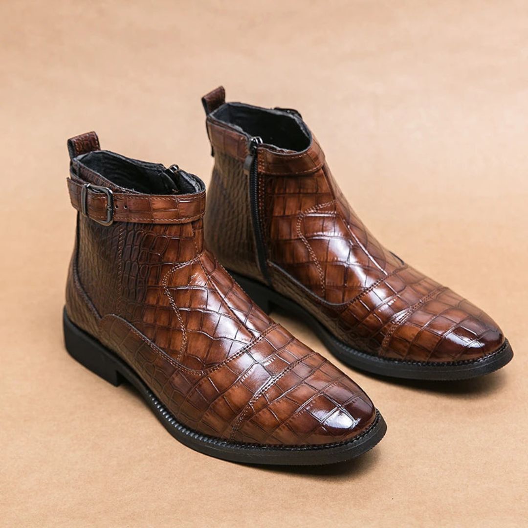 Black faux crocodile leather ankle boots with heritage buckle, zip closure, and stitched sole