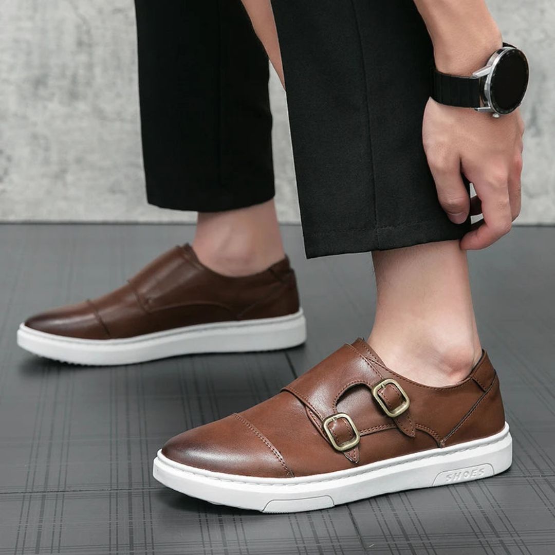 Black leather-look monk strap loafers with dual antique buckles and contrasting white sneaker sole