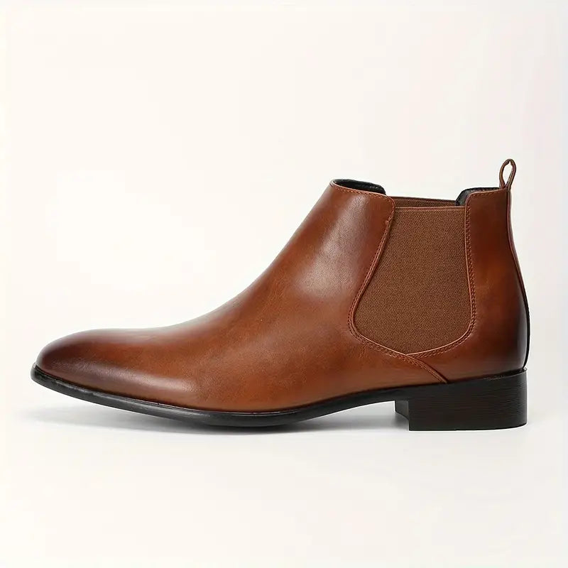 Black pointed-toe Chelsea boots with elastic side panels and sleek minimalist finish