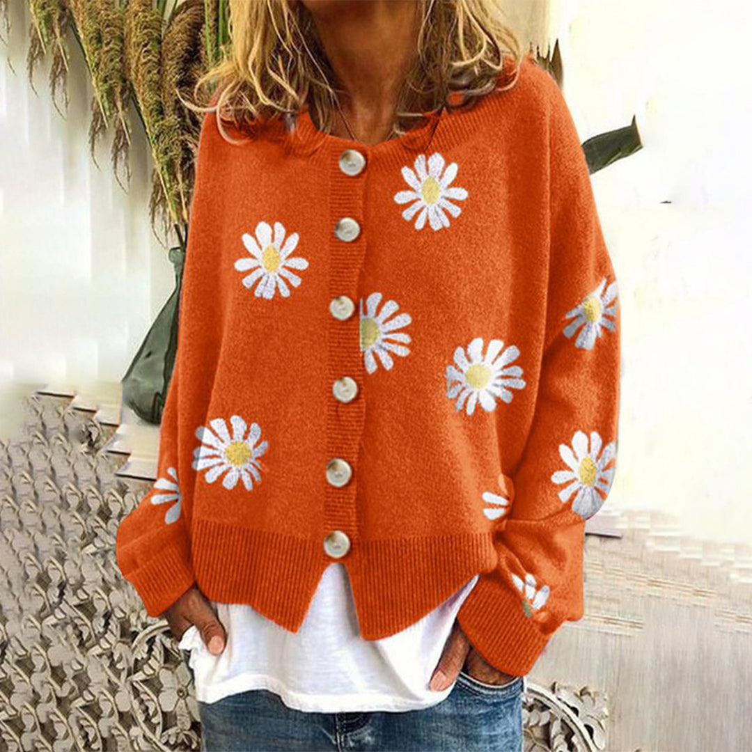 Women's cream relaxed fit button-up cardigan with colorful daisy floral pattern and cozy winter knit