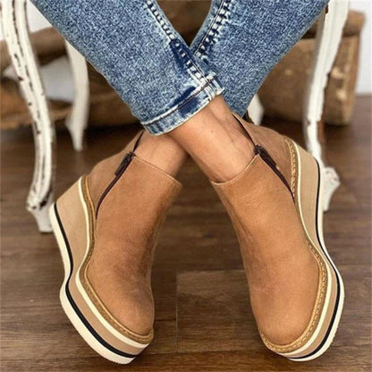 Women's black platform wedge ankle boots with cushioned footbed and elevated stable sole