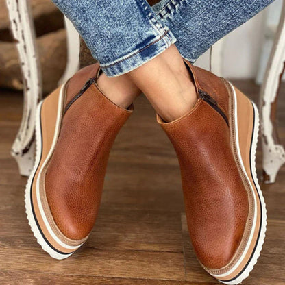 Women's black platform Chelsea boots with sleek ankle silhouette and chunky layered sole for winter