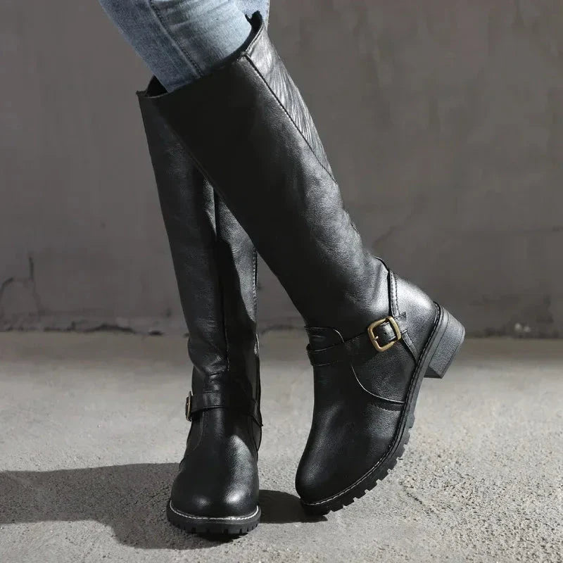 Black knee-high faux leather boots with buckle detail, sleek silhouette for versatile everyday styling