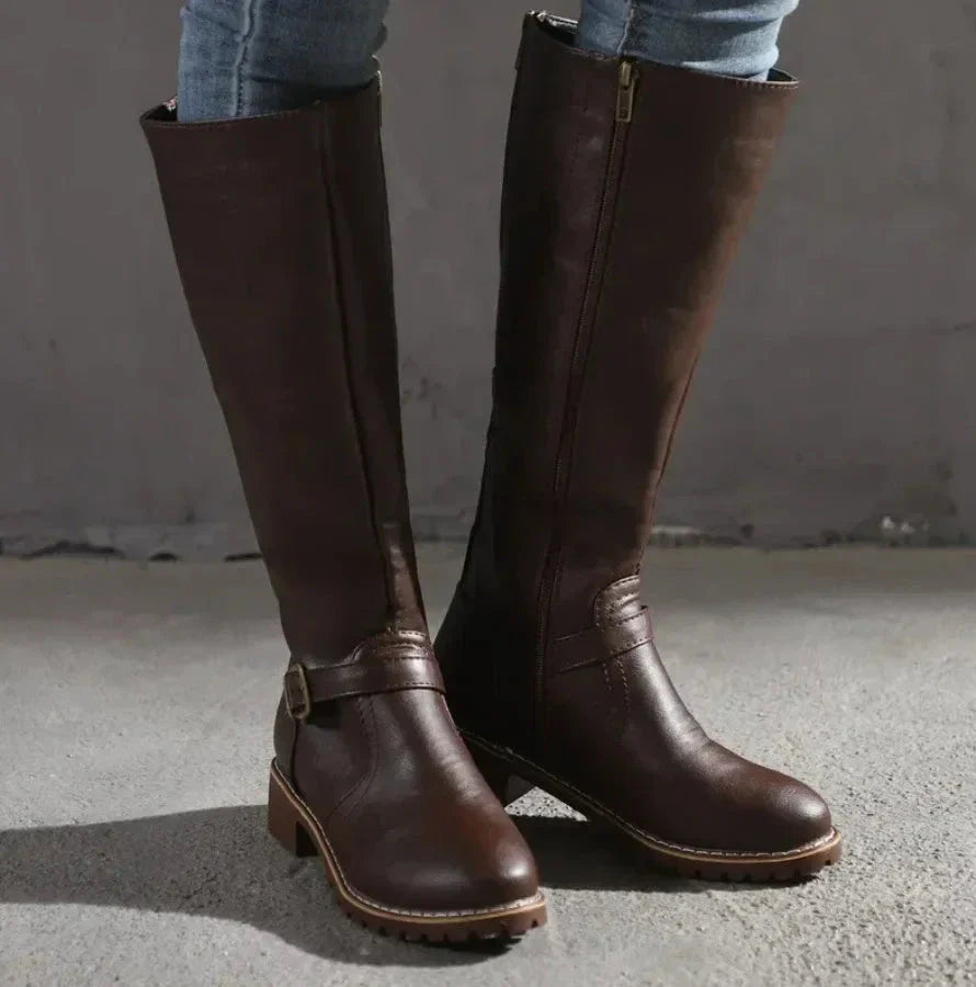 Black knee-high faux leather boots with buckle detail, sleek silhouette for versatile everyday styling