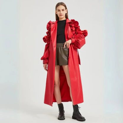 Black faux leather longline trench coat with dramatic ruffled sleeves and cinched waist belt