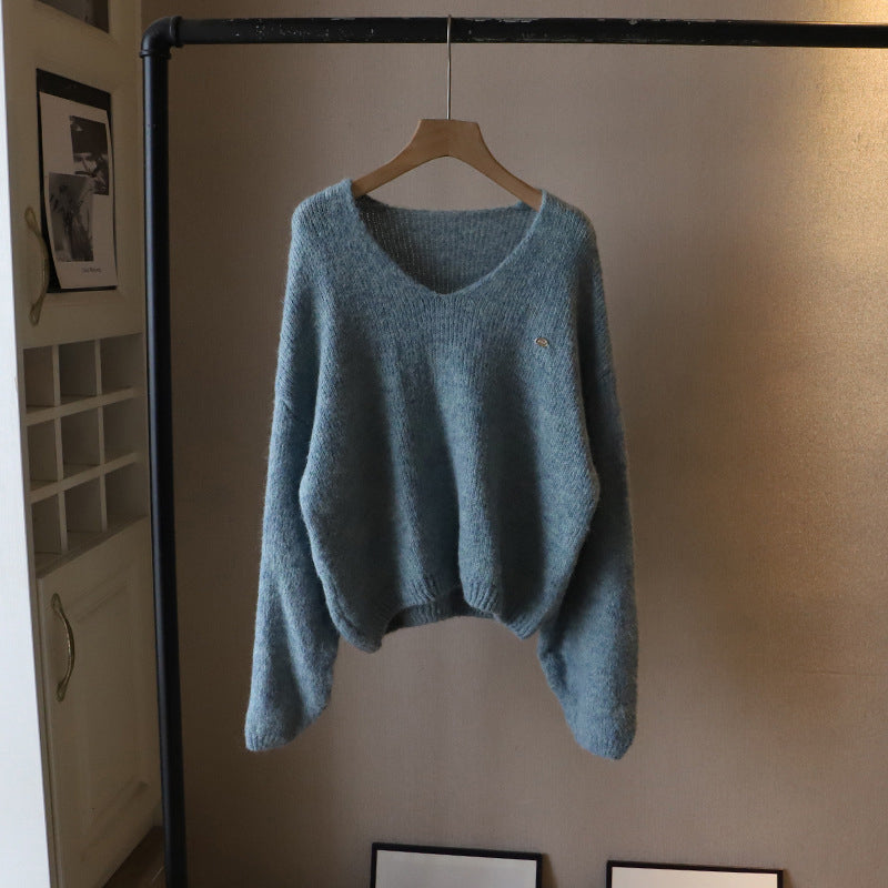 Ivory oversized V-neck sweater with ultra-soft draped knit fabric and elegant relaxed silhouette
