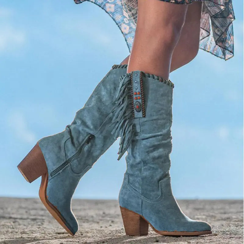 Women's knee-high suede fringe boots in neutral tone with bold tassel detailing for elegant western style