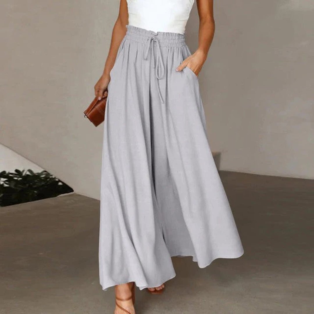 Women's terracotta high waist wide leg pants with smocked drawstring waistband and flowing silhouette