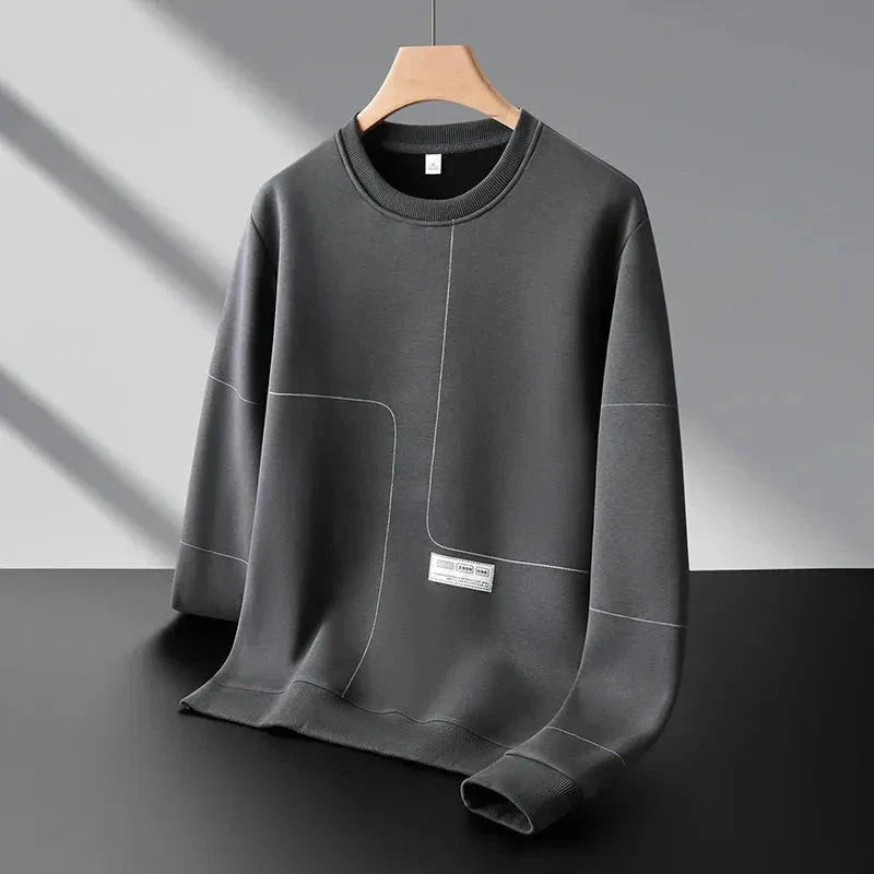 Gray crewneck sweatshirt with subtle stitched panel, ribbed cuffs, minimalist structured fit