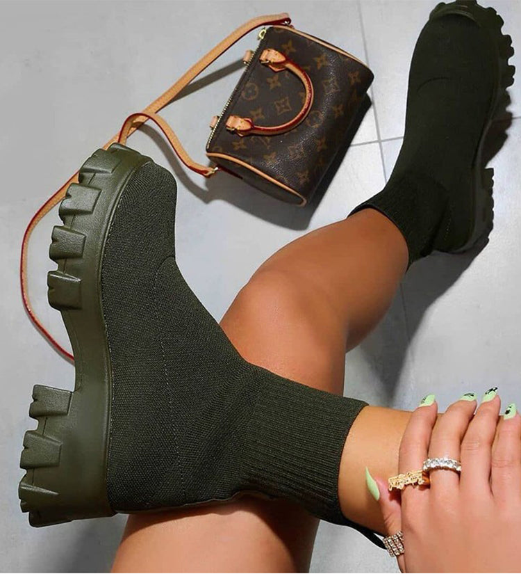 Women's black chunky heel slip-on boots with stretch-fit upper and rugged lug sole for bold streetwear style