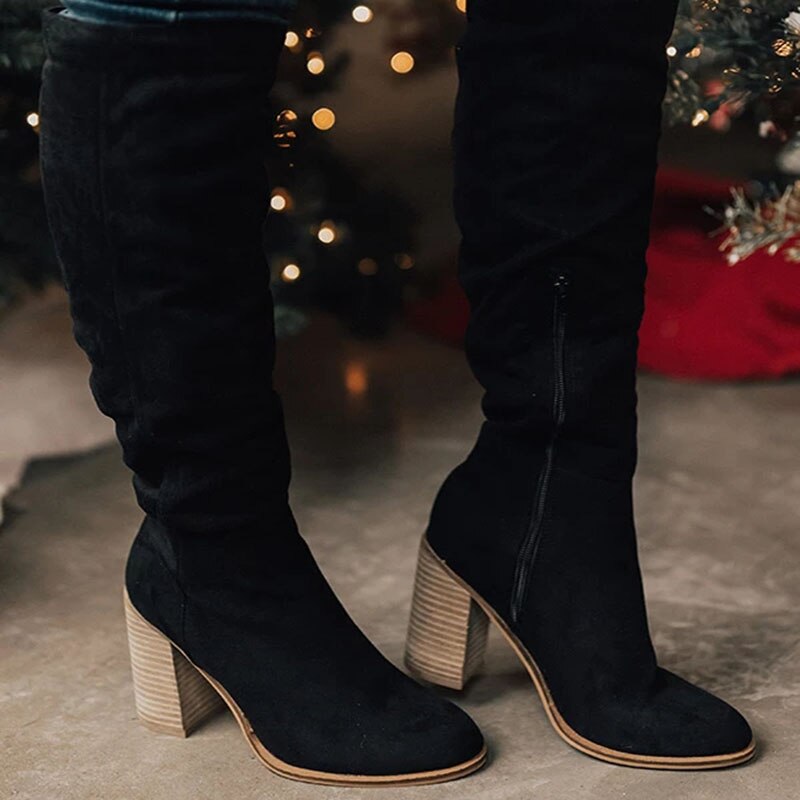 Women's black chic knee-high boots with sleek high heel silhouette, leg-elongating streamlined shaft