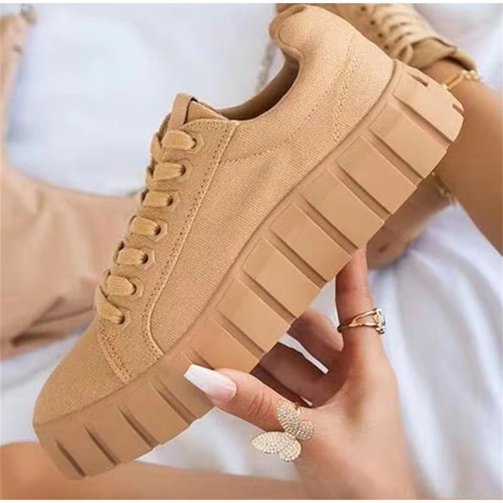 Women's high platform lace-up walking shoes in neutral tones, bold sole elevation, city-ready fashion style