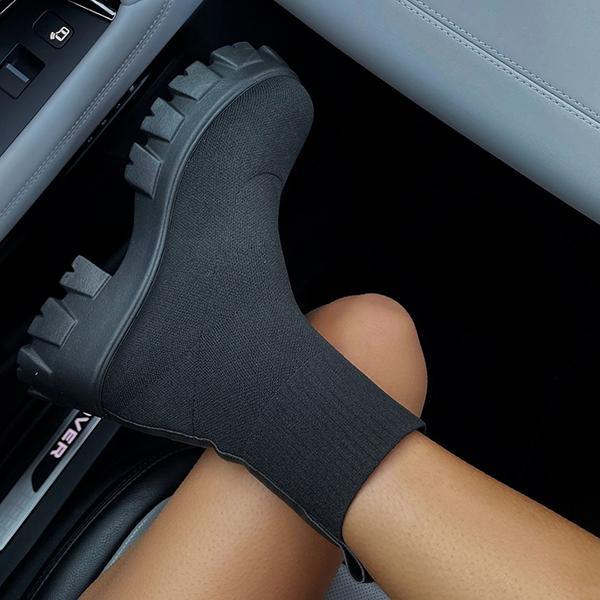 Women's black chunky heel slip-on boots with stretch-fit upper and rugged lug sole for bold streetwear style