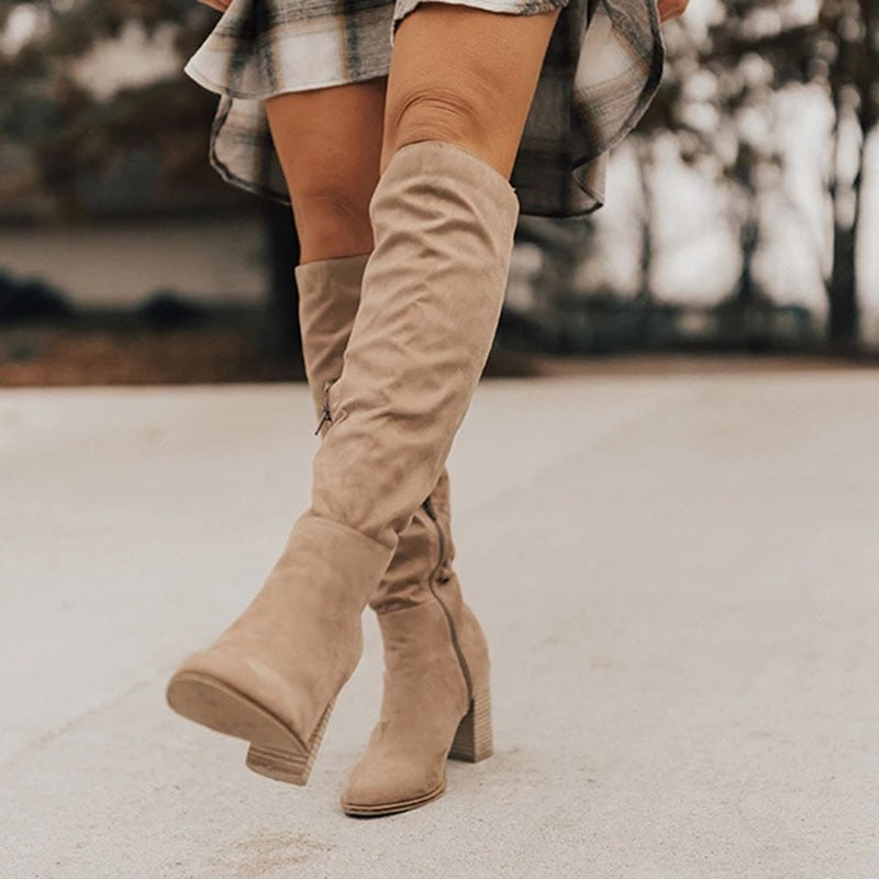 Black women's knee-high boots with stiletto heel, sleek shaft silhouette for elegant day-to-night style