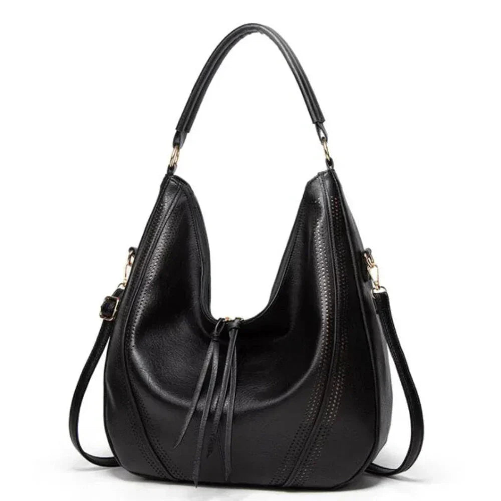 Wavlynn Jean vegan leather slouchy hobo bag with perforated detailing and adjustable crossbody strap