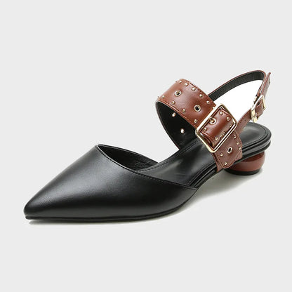 Women's studded flat sandals with wide vamp strap, metal stud embellishments, and adjustable buckle closure