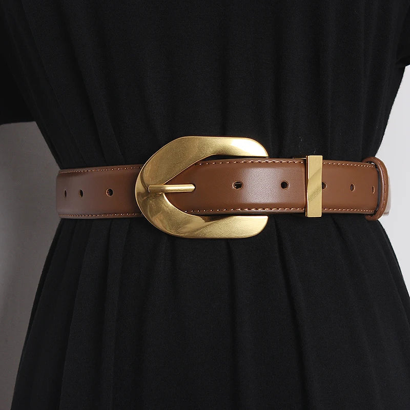Black vegan leather waistband belt with polished oversized statement buckle, bold adjustable style