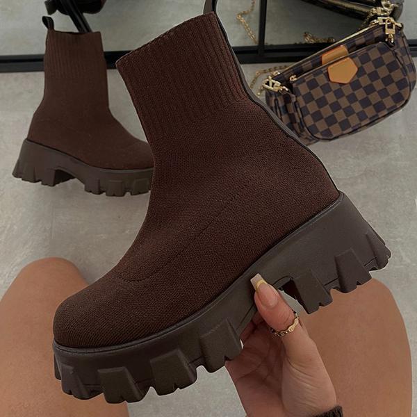Women's black chunky heel slip-on boots with stretch-fit upper and rugged lug sole for bold streetwear style
