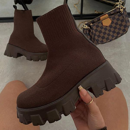 Women's black chunky heel slip-on boots with stretch-fit upper and rugged lug sole for bold streetwear style