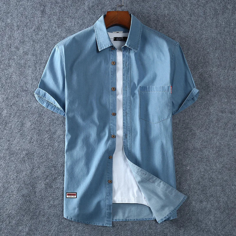 Faded blue denim short sleeve shirt relaxed fit, casual untucked style with worn-in vintage wash