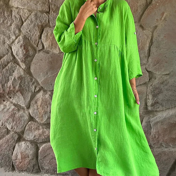 Women's flowy elegant midi dress in soft hue with defined waist and graceful flowing skirt silhouette