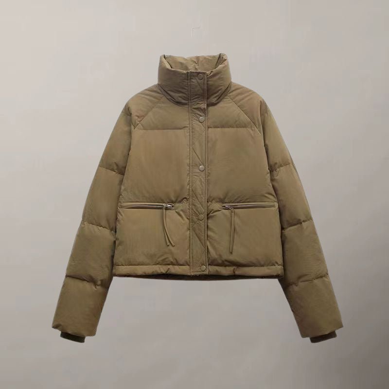 Women's cropped cotton puffer jacket in neutral tone with thick padding and clean structured lines