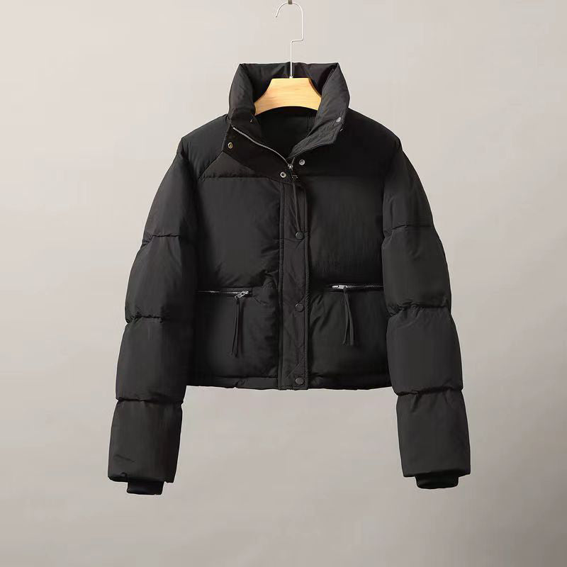 Women's cropped cotton puffer jacket in neutral tones with thick padding and clean structured lines