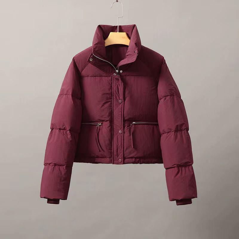 Women's cropped cotton puffer jacket in neutral tone with thick padding and clean structured lines