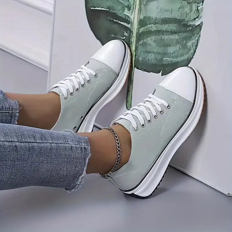Women's white canvas high-top sneakers with chunky sole and protective rubber toe cap