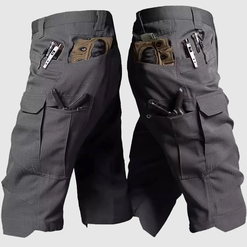 Men's green camo cargo shorts with zipper fly and multi-pocket design for outdoor adventures