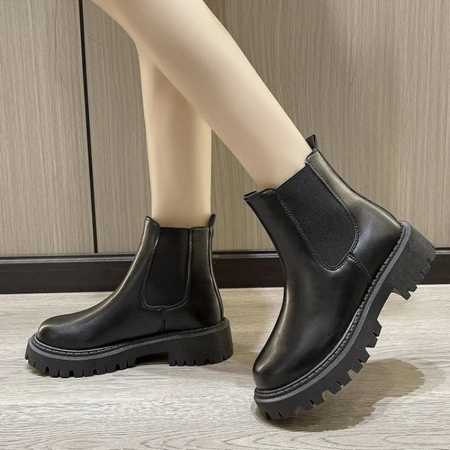 Black Chelsea boots with chunky anti-slip rubber sole, sleek streamlined silhouette for city wear