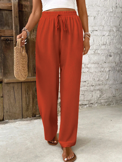 Skylar ivory high-waist lounge pants with chic button accents and airy minimalist silhouette